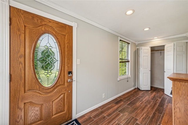 foyer entrance featuring crown molding and dark hardwood / wood-style flooring