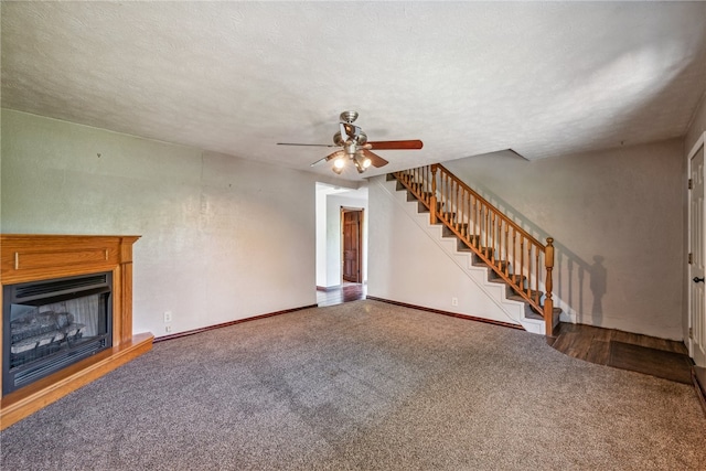 unfurnished living room featuring carpet, a textured ceiling, and ceiling fan