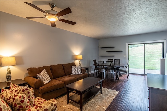 living room featuring a textured ceiling, dark hardwood / wood-style floors, and ceiling fan