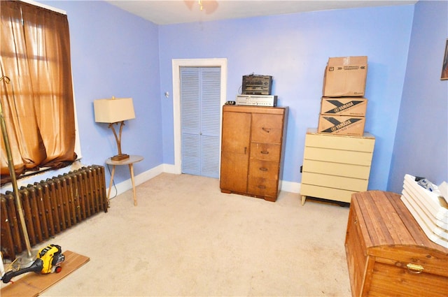 miscellaneous room featuring light carpet and radiator