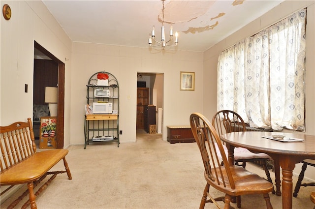 office with light carpet and a notable chandelier