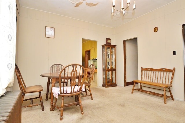 carpeted dining room with a notable chandelier