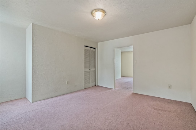 carpeted spare room featuring a textured ceiling