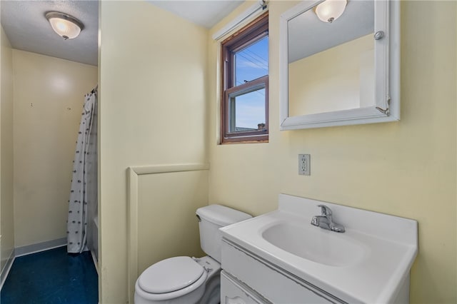 bathroom with vanity, walk in shower, and toilet