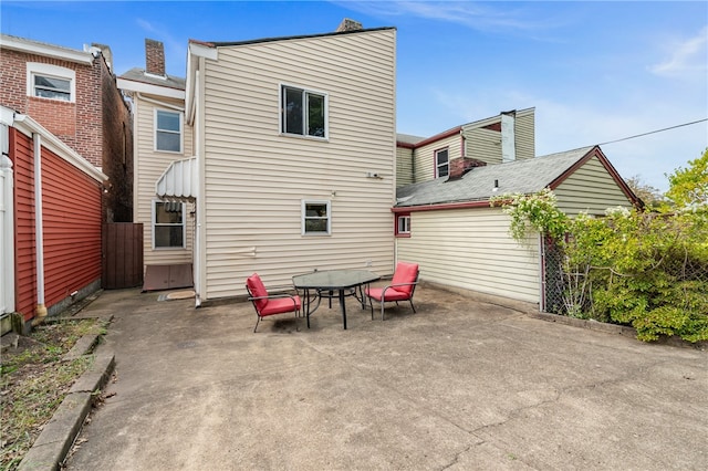 rear view of property featuring a patio area