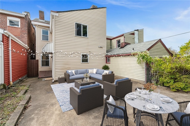 back of house featuring a patio and an outdoor living space