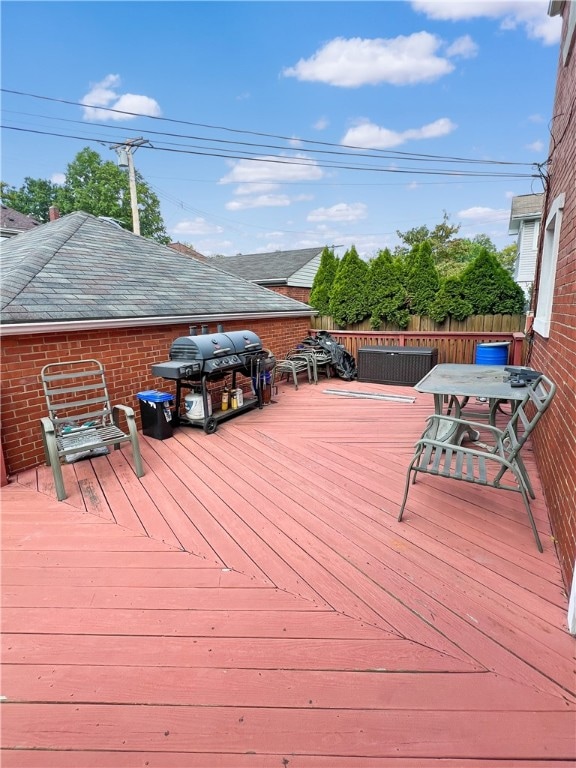 wooden terrace featuring a grill