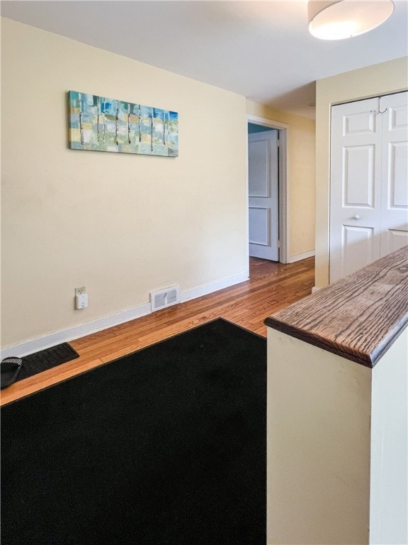 interior space with wood-type flooring and a closet