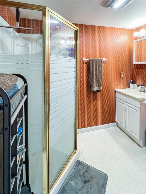 bathroom with tile patterned flooring, vanity, and a shower with shower door