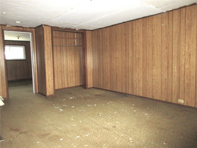 basement featuring wooden walls