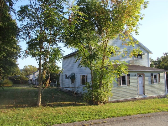 view of property exterior featuring a lawn