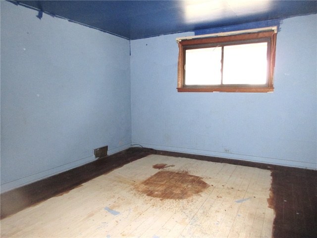 empty room with hardwood / wood-style floors