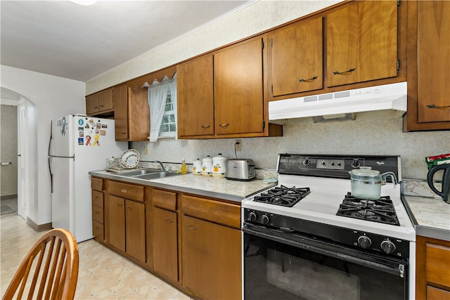 kitchen featuring sink and white appliances