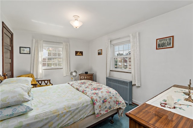 bedroom with carpet flooring and radiator heating unit