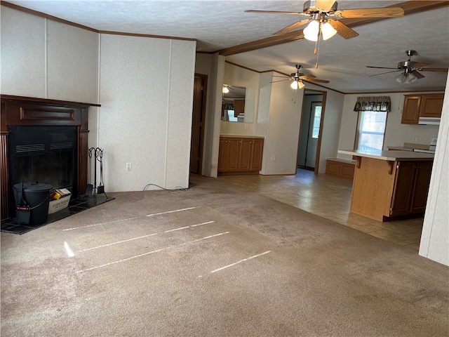 unfurnished living room with ornamental molding, ceiling fan, light colored carpet, and a textured ceiling