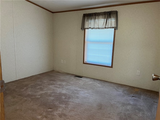 carpeted spare room with crown molding