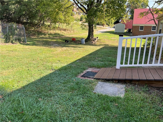 view of yard with a deck and a shed