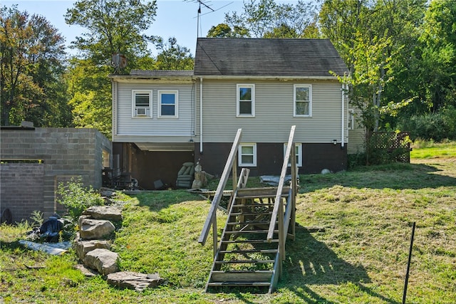 rear view of house featuring a yard