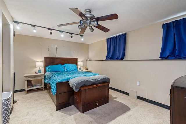 bedroom with rail lighting, light carpet, and ceiling fan