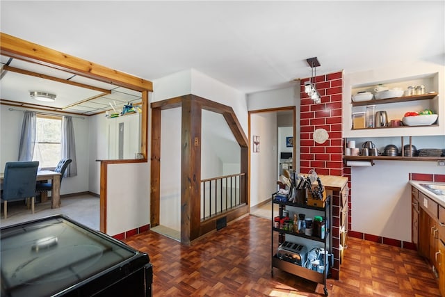 interior space featuring hanging light fixtures and dark parquet floors