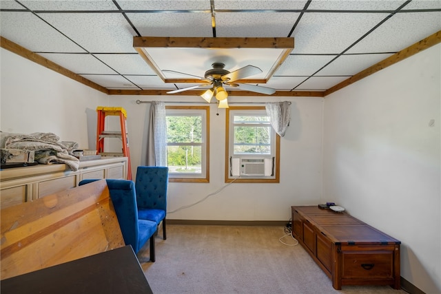 carpeted bedroom with ceiling fan, cooling unit, and a drop ceiling