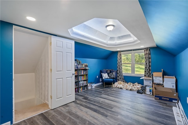 living area featuring vaulted ceiling and hardwood / wood-style floors