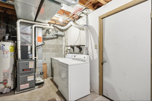 laundry area featuring gas water heater, washer / clothes dryer, and heating unit