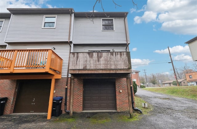 rear view of house featuring a garage