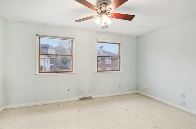 carpeted empty room featuring ceiling fan