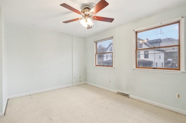 unfurnished room with ceiling fan and light carpet