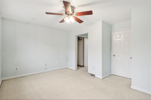 unfurnished bedroom with ceiling fan and light colored carpet