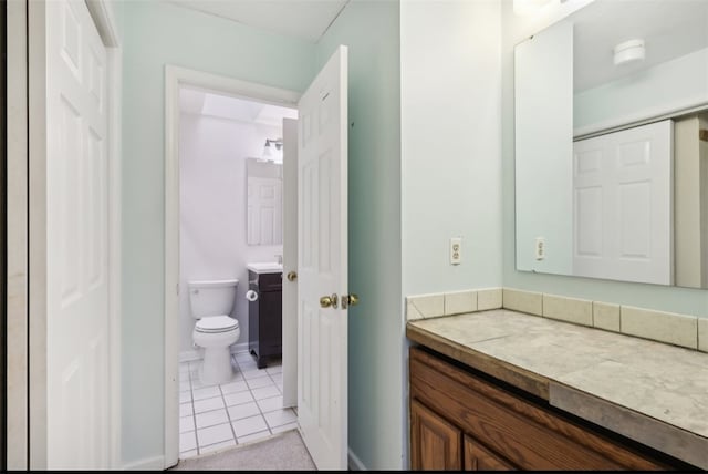 bathroom featuring tile patterned flooring, vanity, and toilet