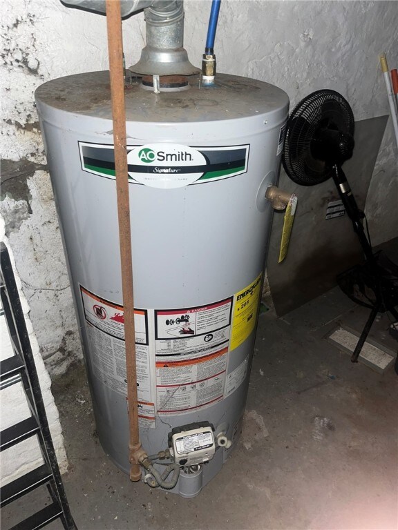 utility room with water heater