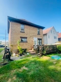 back of house with a lawn and a wooden deck