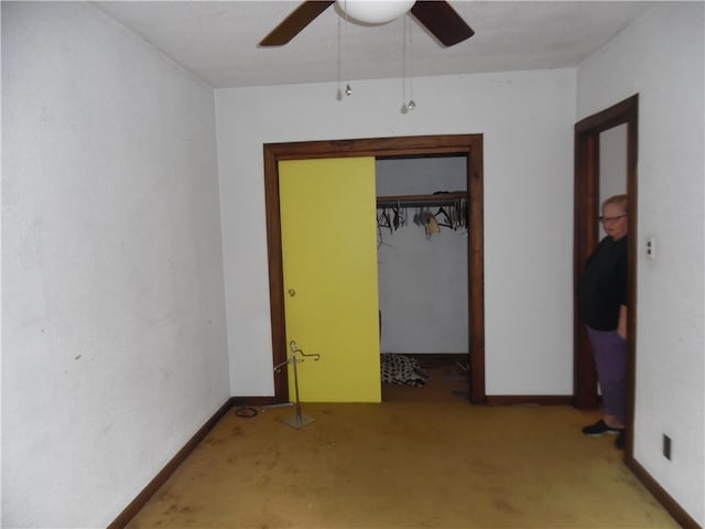 unfurnished bedroom featuring light carpet, a closet, and ceiling fan