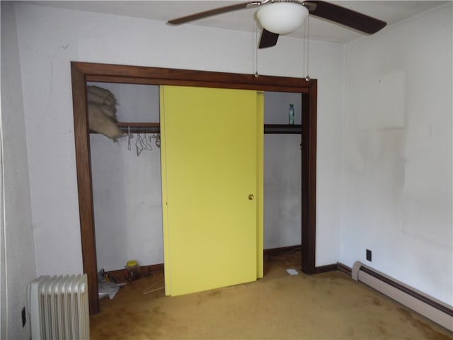 unfurnished bedroom featuring light carpet, baseboard heating, radiator heating unit, and ceiling fan