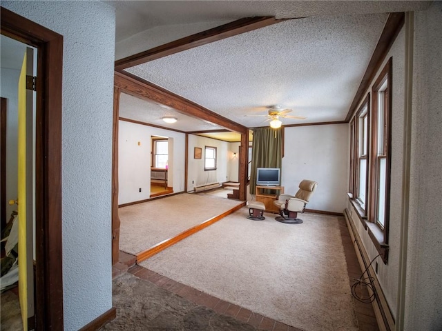 sitting room featuring carpet flooring, a baseboard heating unit, ceiling fan, crown molding, and a textured ceiling