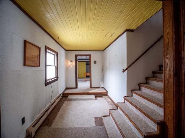 hallway featuring wood ceiling, ornamental molding, and a baseboard heating unit