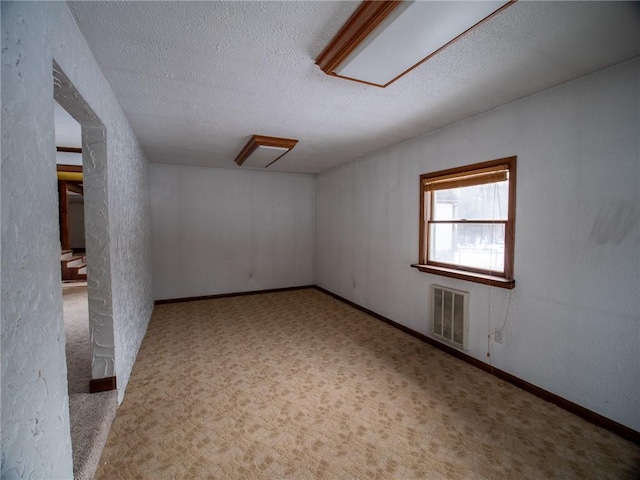 bonus room featuring light colored carpet and a textured ceiling