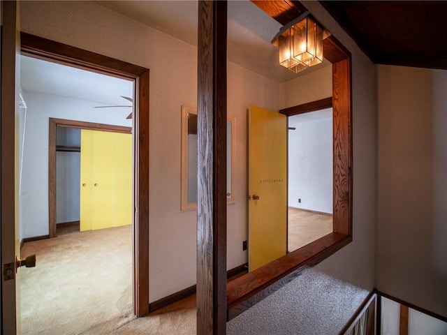 hallway featuring light colored carpet