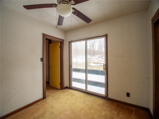 carpeted spare room with a textured ceiling