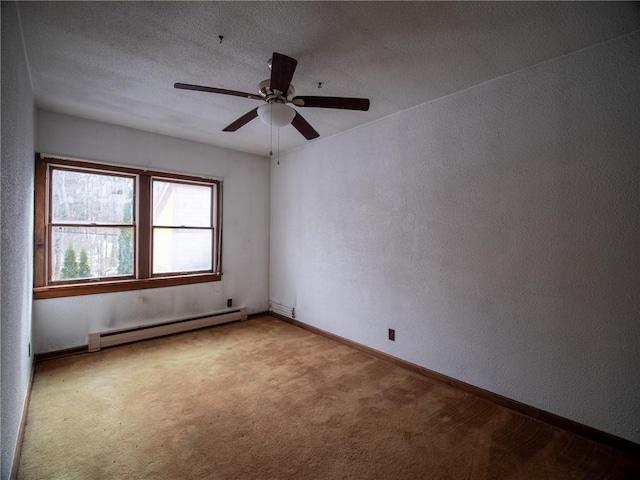 carpeted spare room featuring baseboard heating, ceiling fan, and a textured ceiling