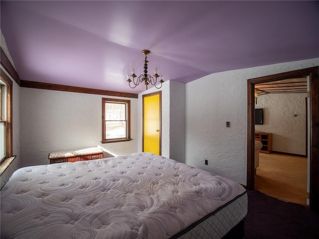 bedroom featuring an inviting chandelier, vaulted ceiling, and carpet flooring