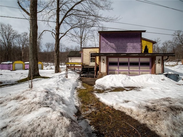 snow covered property featuring a garage