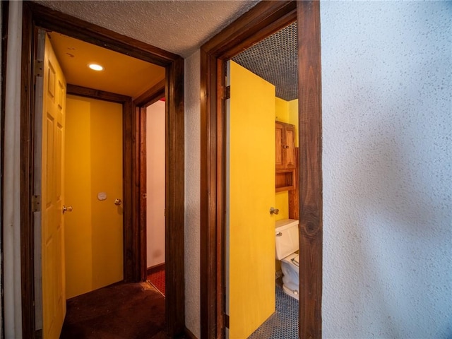 corridor featuring a textured ceiling