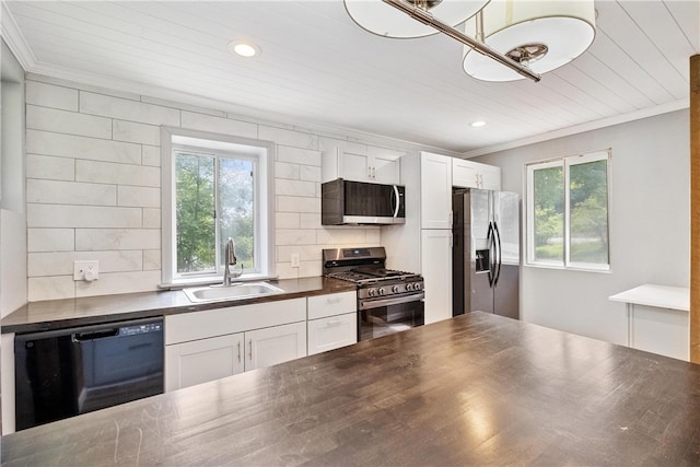 kitchen with plenty of natural light, white cabinetry, sink, and appliances with stainless steel finishes