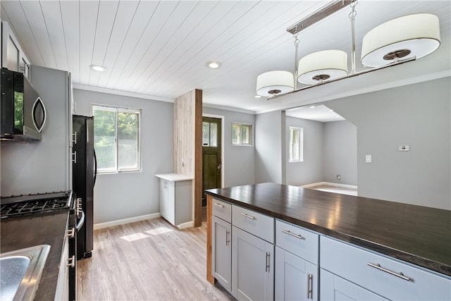 kitchen with wooden ceiling, ornamental molding, appliances with stainless steel finishes, decorative light fixtures, and light hardwood / wood-style floors