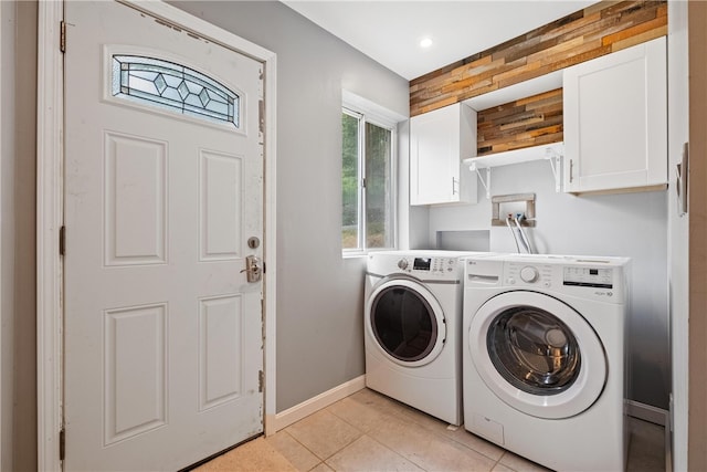 washroom with cabinets, light tile patterned floors, and separate washer and dryer