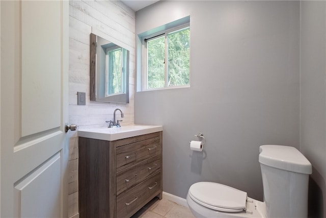 bathroom with tile patterned flooring, vanity, and toilet