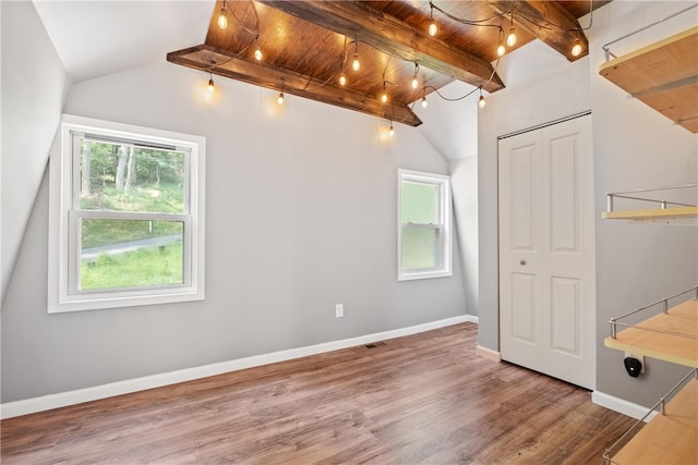 bonus room featuring hardwood / wood-style flooring, lofted ceiling with beams, and wooden ceiling